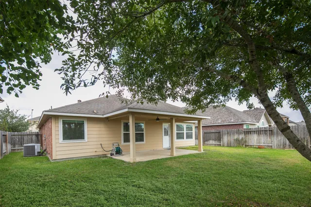 a front view of a house with a garden and yard