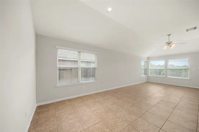 an empty room with a empty space and windows