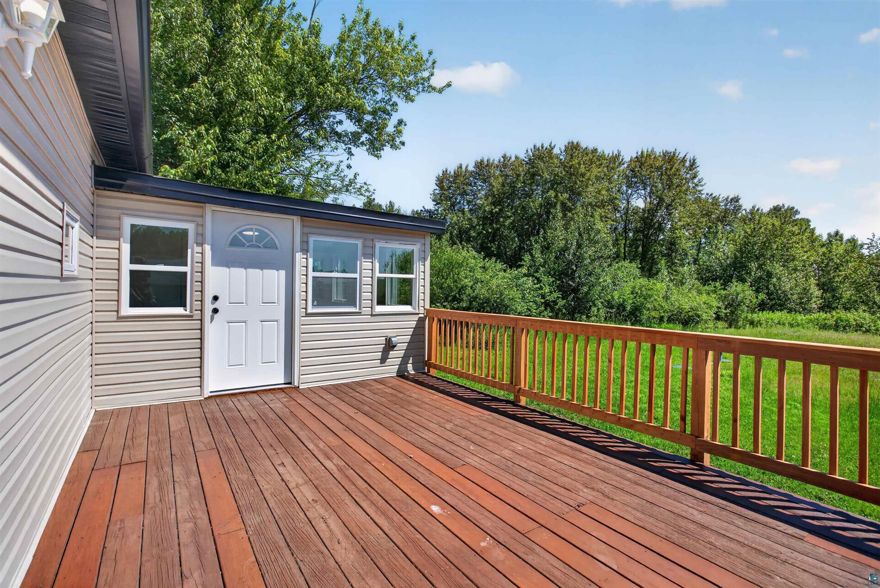 5868 Rice Lake Road Duluth, MN 55803 - Photo 36 of 39 Spacious wood-finish deck with a natural wood railing
