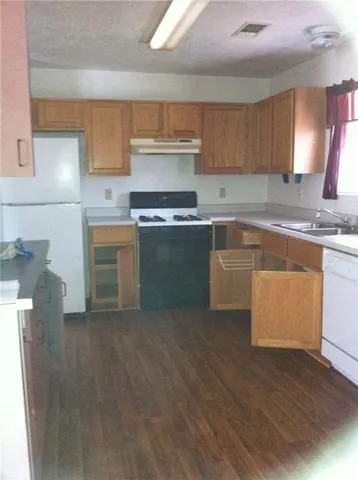 a kitchen with stainless steel appliances granite countertop a stove a sink and a refrigerator