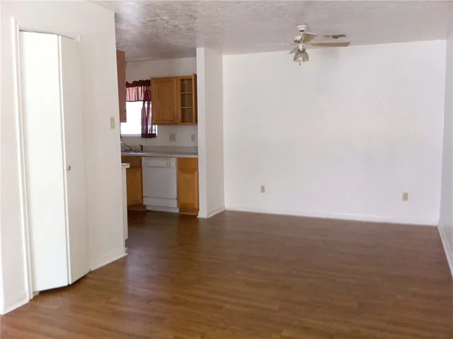 a view of a kitchen from the hallway with a stove