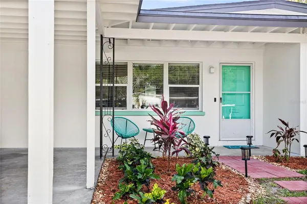 a front view of a house with outdoor seating