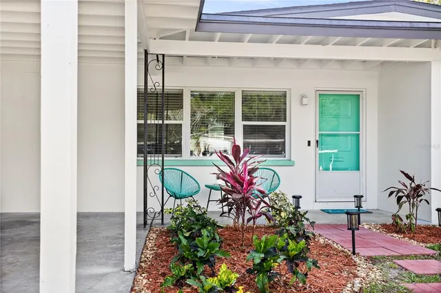 a front view of a house with outdoor seating