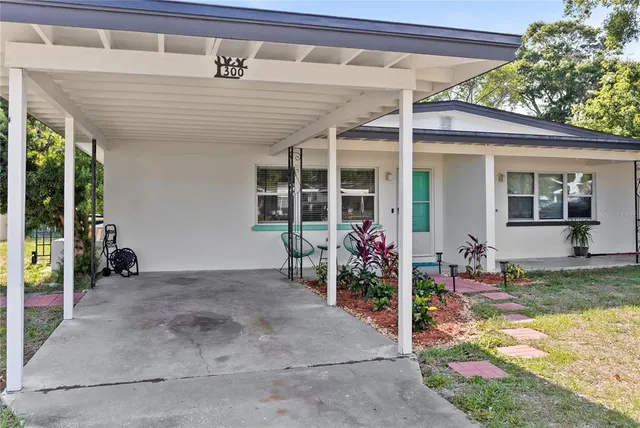 a view of a patio with table and chairs and potted plants