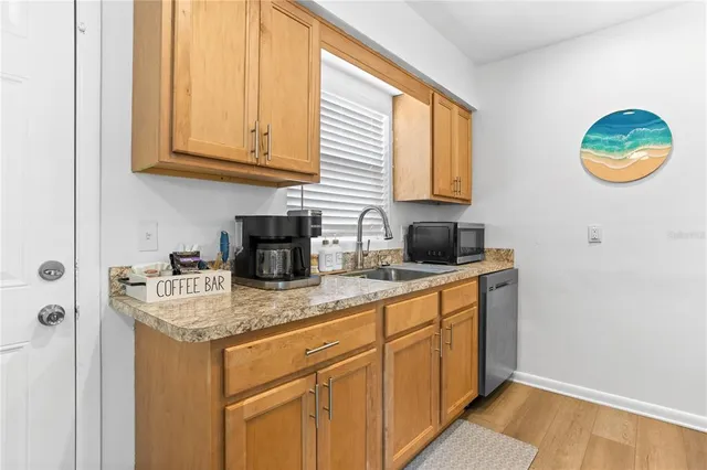 a kitchen with stainless steel appliances granite countertop a sink and a cabinets
