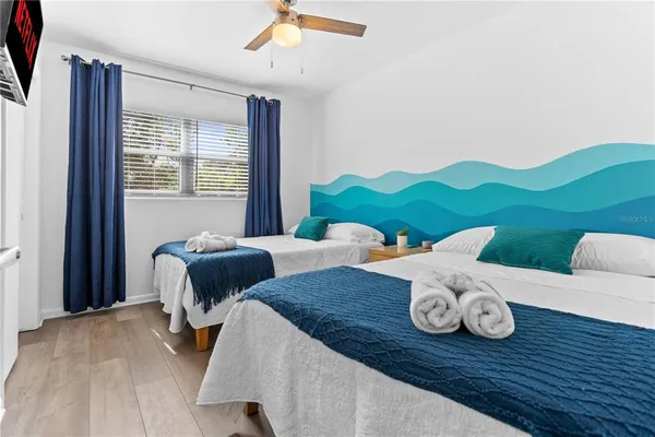 a bedroom with a bed and a chair