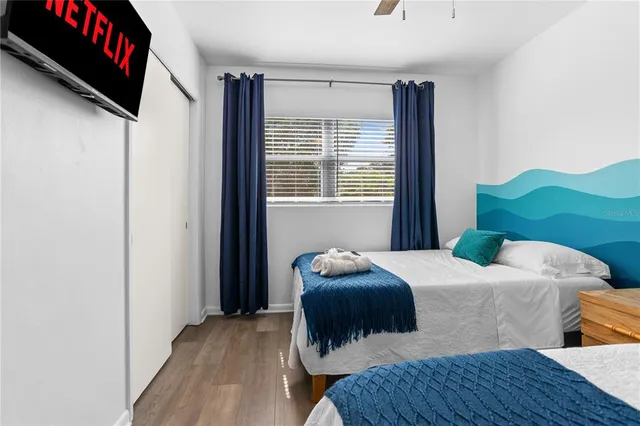 a bedroom with a bed and a flat screen tv