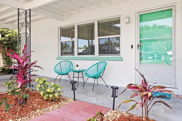a view of a room that has a table chair and a window