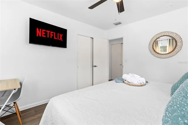 a living room with furniture a flat screen tv and a wall with a large window