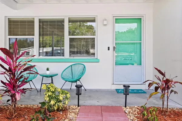a living room with furniture a rug and a flat screen tv