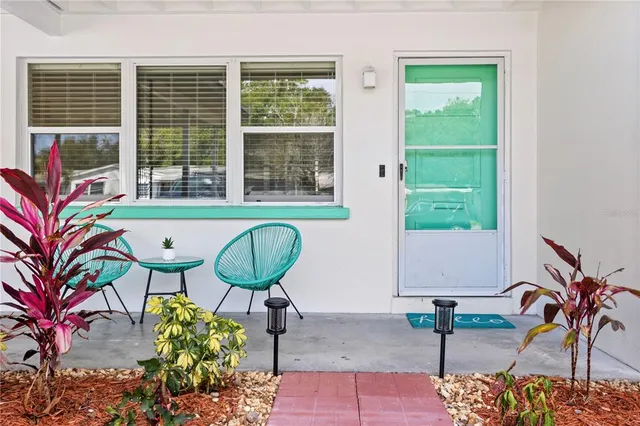 a living room with furniture a rug and a flat screen tv
