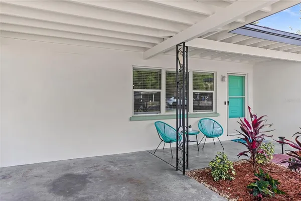 a living room with furniture a rug and a chair