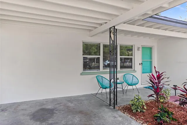 a living room with furniture a rug and a chair