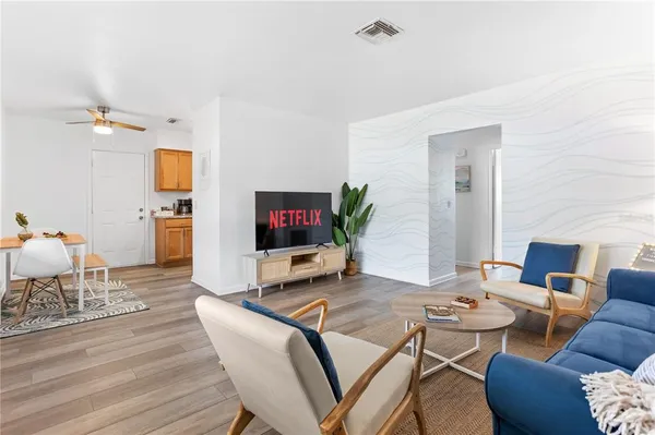 a living room with furniture a couch and a lamp