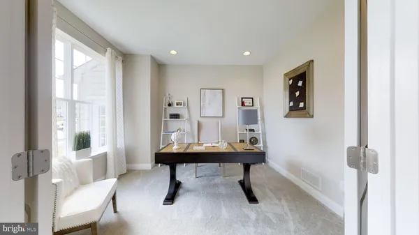 a room with furniture wall paintings and a window