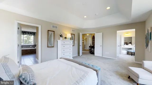 a spacious bedroom with a bed and a couch