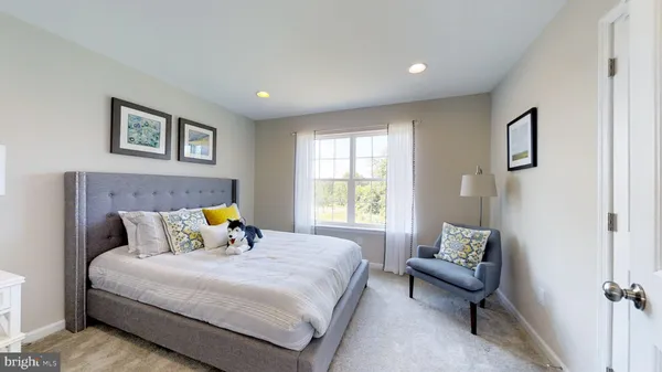 a bedroom with bed and a couch