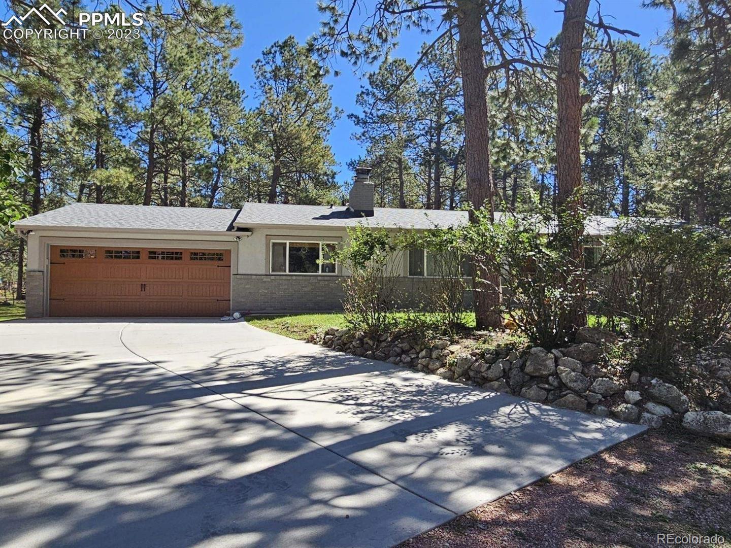 8020 Cyprus Road Colorado Springs, CO 80908 - Photo 1 of 42 a front view of a house with a yard and trees