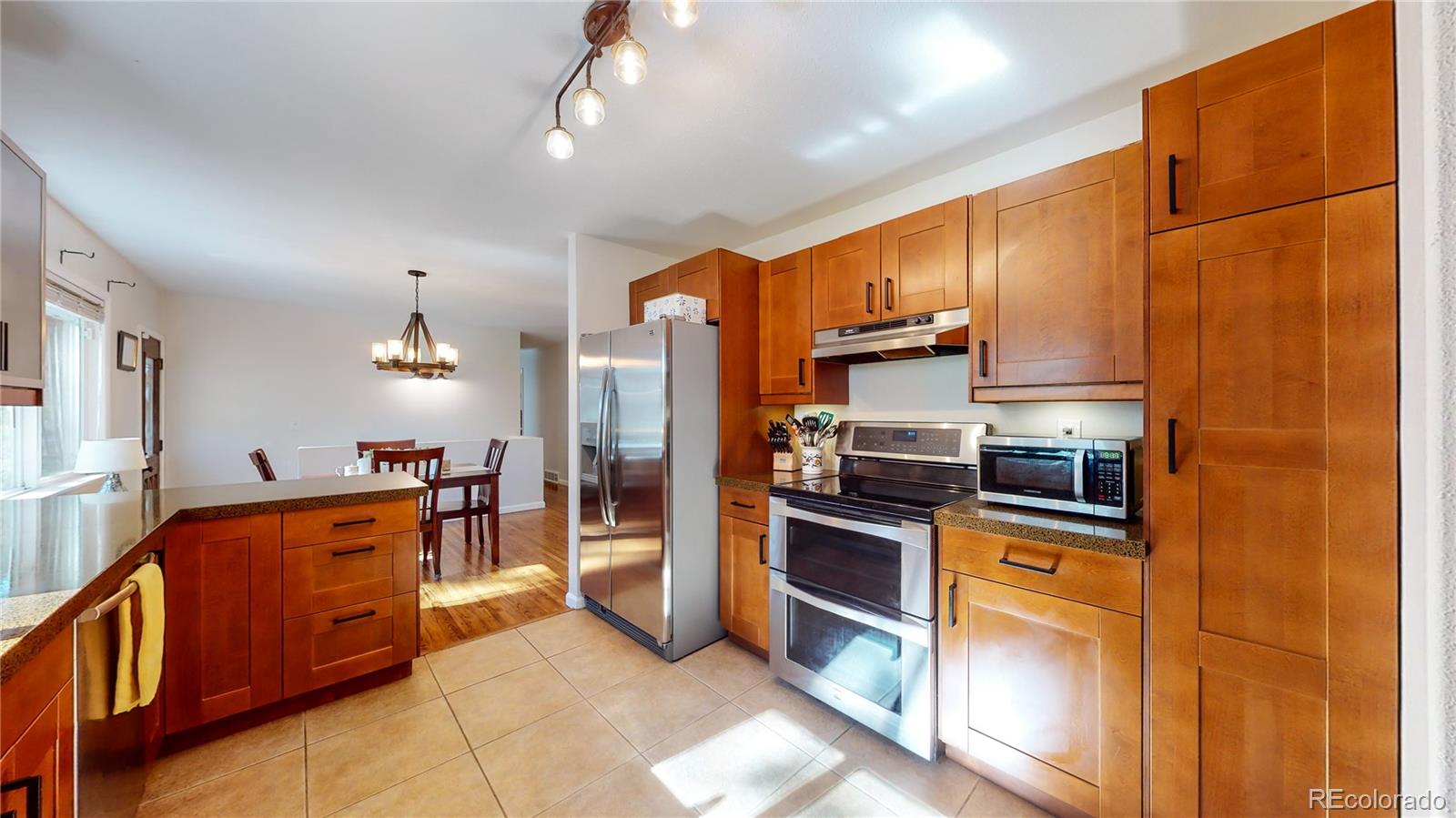 8020 Cyprus Road Colorado Springs, CO 80908 - Photo 12 of 42 a kitchen with stainless steel appliances granite countertop a refrigerator a stove and a sink