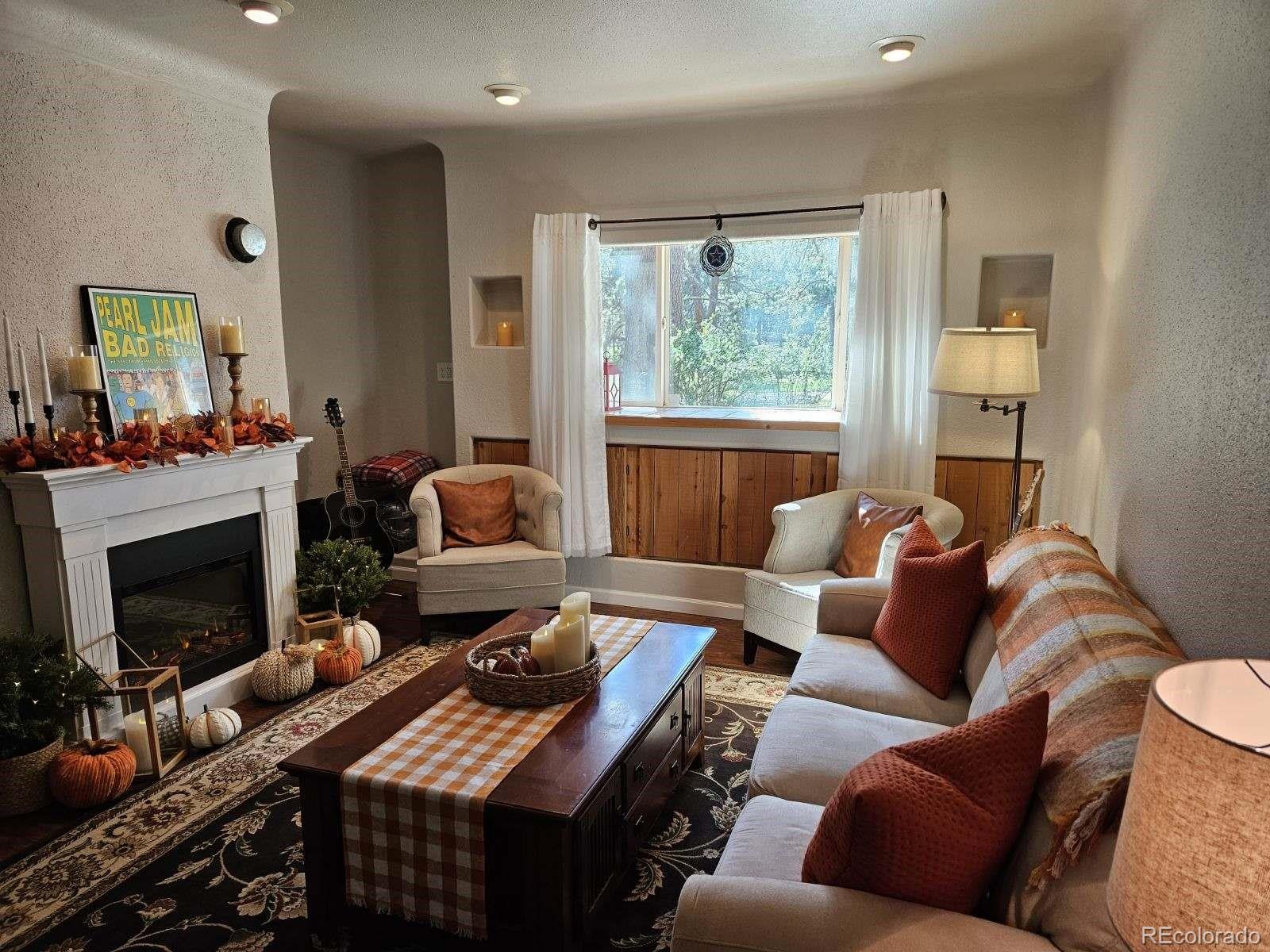 8020 Cyprus Road Colorado Springs, CO 80908 - Photo 13 of 42 a living room with furniture and a fireplace