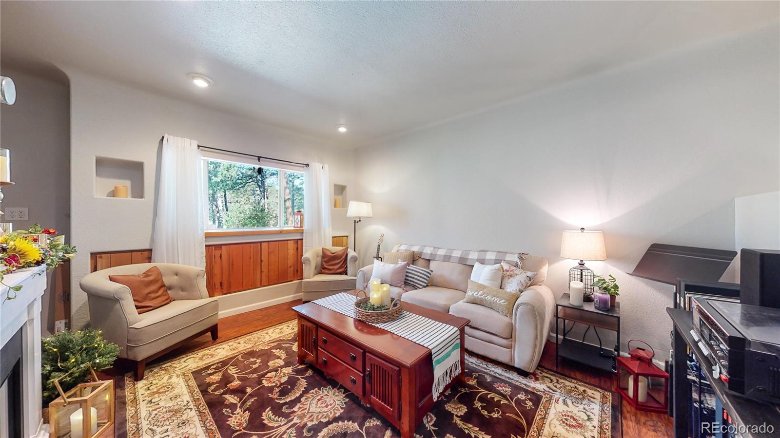 8020 Cyprus Road Colorado Springs, CO 80908 - Photo 14 of 42 a living room with furniture a rug and a window