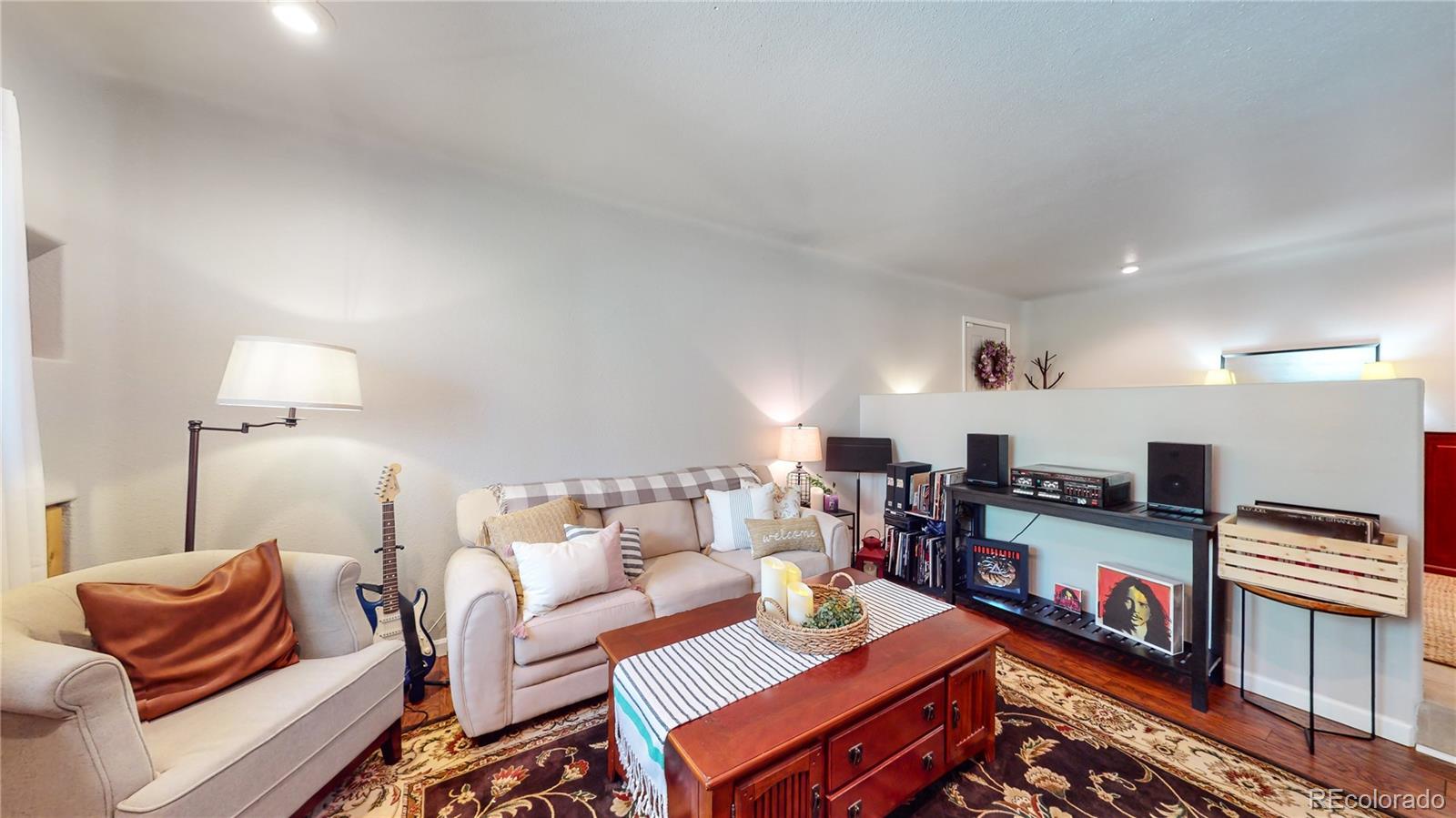 8020 Cyprus Road Colorado Springs, CO 80908 - Photo 15 of 42 a living room with furniture and a lamp