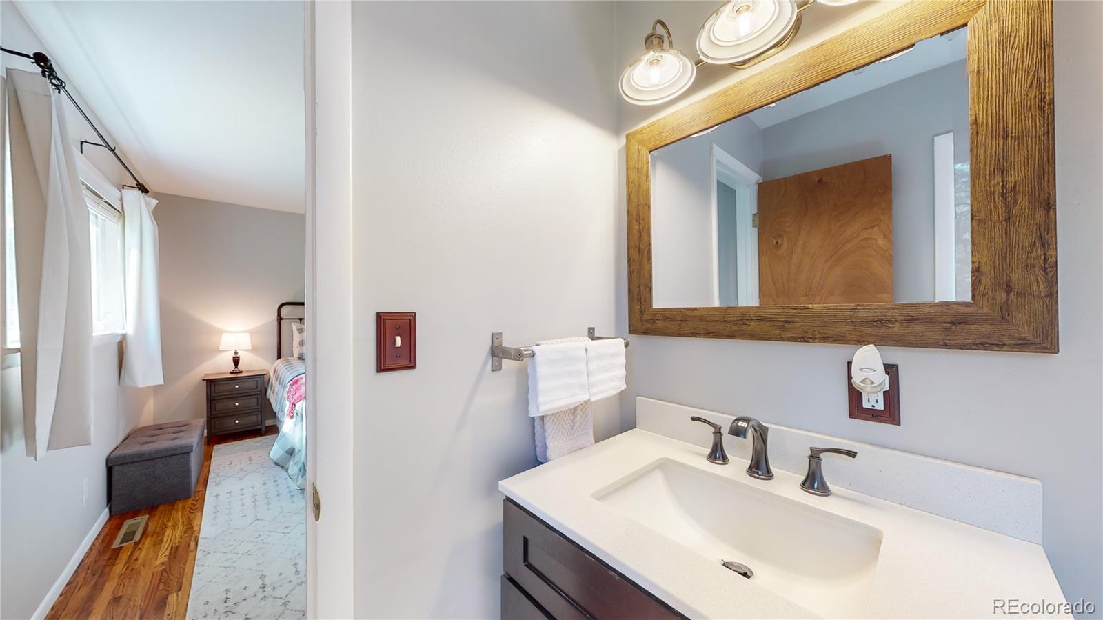 8020 Cyprus Road Colorado Springs, CO 80908 - Photo 23 of 42 a en suite bathroom with a sink and a mirror