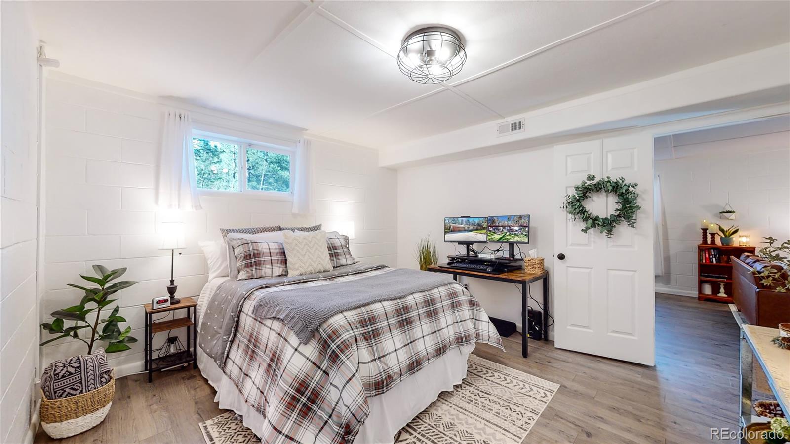 8020 Cyprus Road Colorado Springs, CO 80908 - Photo 28 of 42 a bedroom with bed and a potted plant