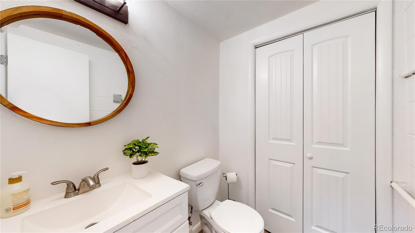 8020 Cyprus Road Colorado Springs, CO 80908 - Photo 29 of 42 a bathroom with a sink and a mirror