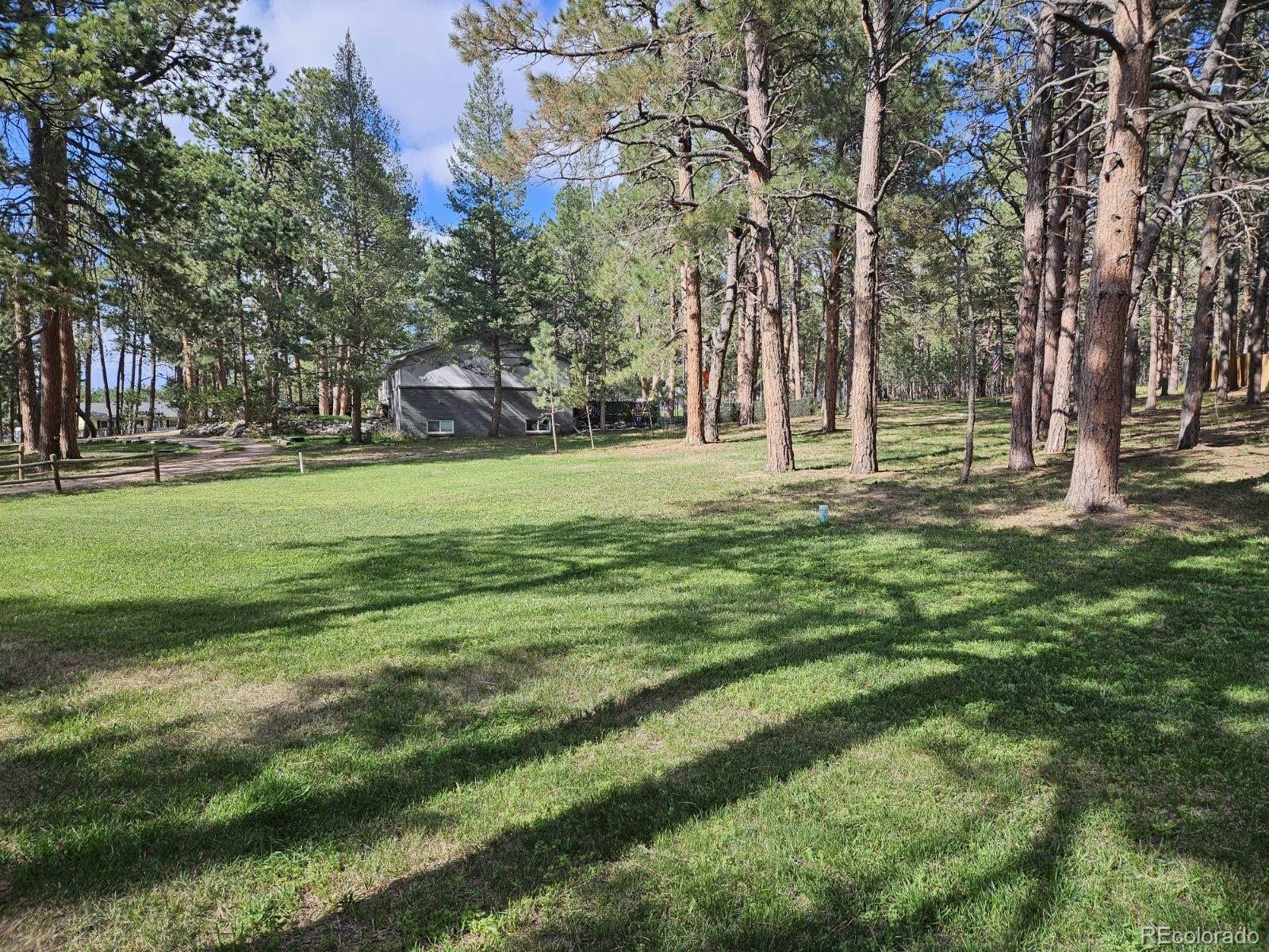 8020 Cyprus Road Colorado Springs, CO 80908 - Photo 37 of 42 a big yard with lots of green space and trees