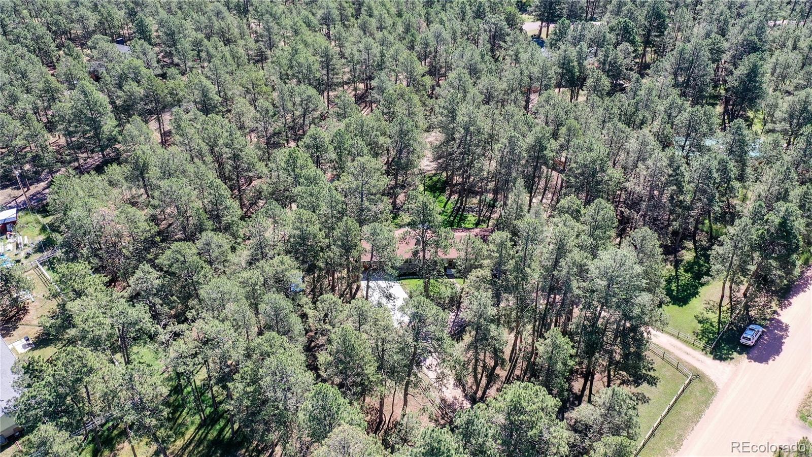 8020 Cyprus Road Colorado Springs, CO 80908 - Photo 40 of 42 an aerial view of residential house with outdoor space and trees all around
