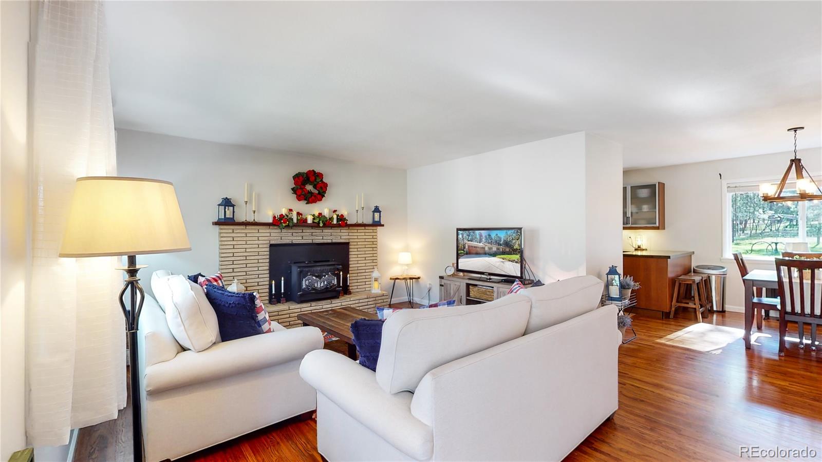8020 Cyprus Road Colorado Springs, CO 80908 - Photo 5 of 42 a living room with furniture and a fireplace
