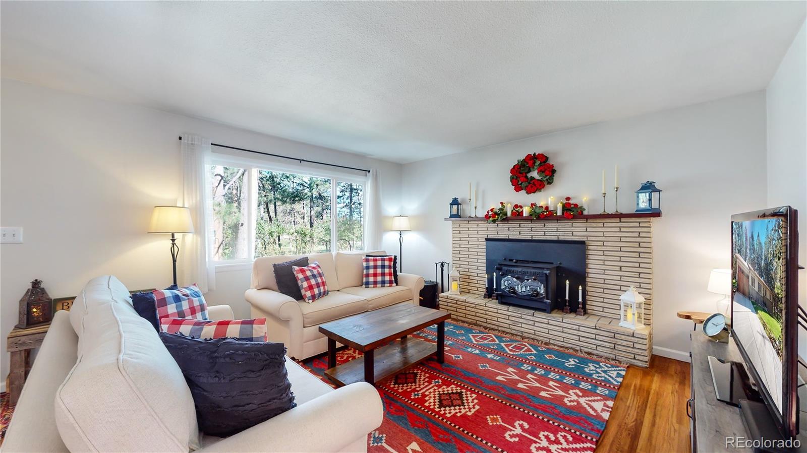 8020 Cyprus Road Colorado Springs, CO 80908 - Photo 6 of 42 a living room with furniture fireplace and flat screen tv