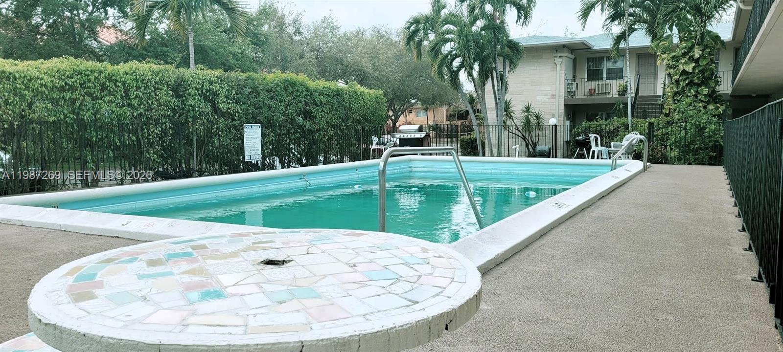 a view of a swimming pool with a patio