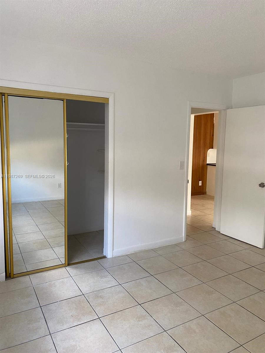1755 Northeast 116th Road, Unit 8 North Miami, FL 33181 - Photo 13 of 23 an empty room with a bathroom