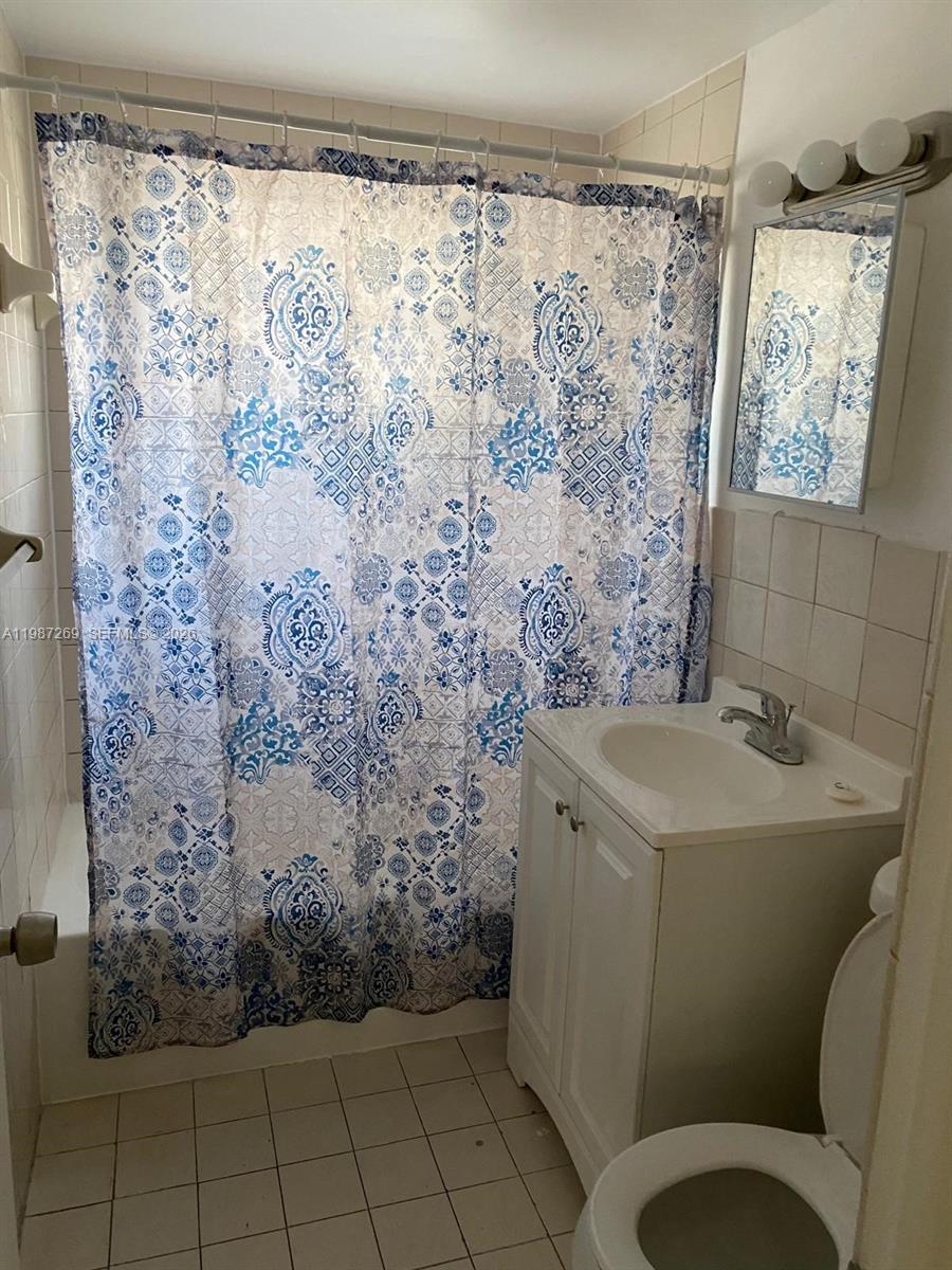 1755 Northeast 116th Road, Unit 8 North Miami, FL 33181 - Photo 14 of 23 a bathroom with a sink toilet and shower