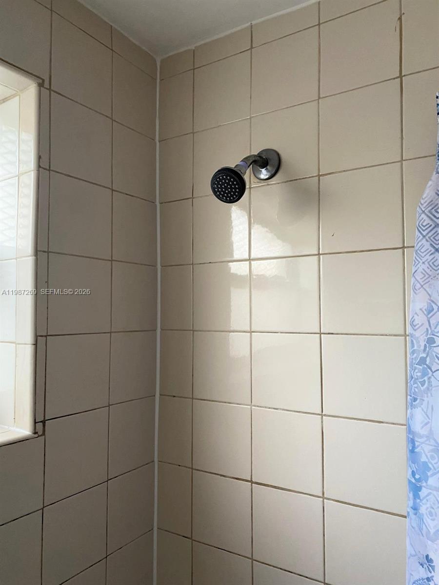 1755 Northeast 116th Road, Unit 8 North Miami, FL 33181 - Photo 15 of 23 a bathroom with a shower