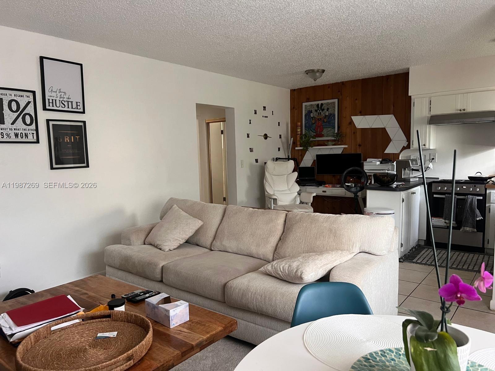 1755 Northeast 116th Road, Unit 8 North Miami, FL 33181 - Photo 5 of 23 a living room with furniture a flat screen tv and a couch