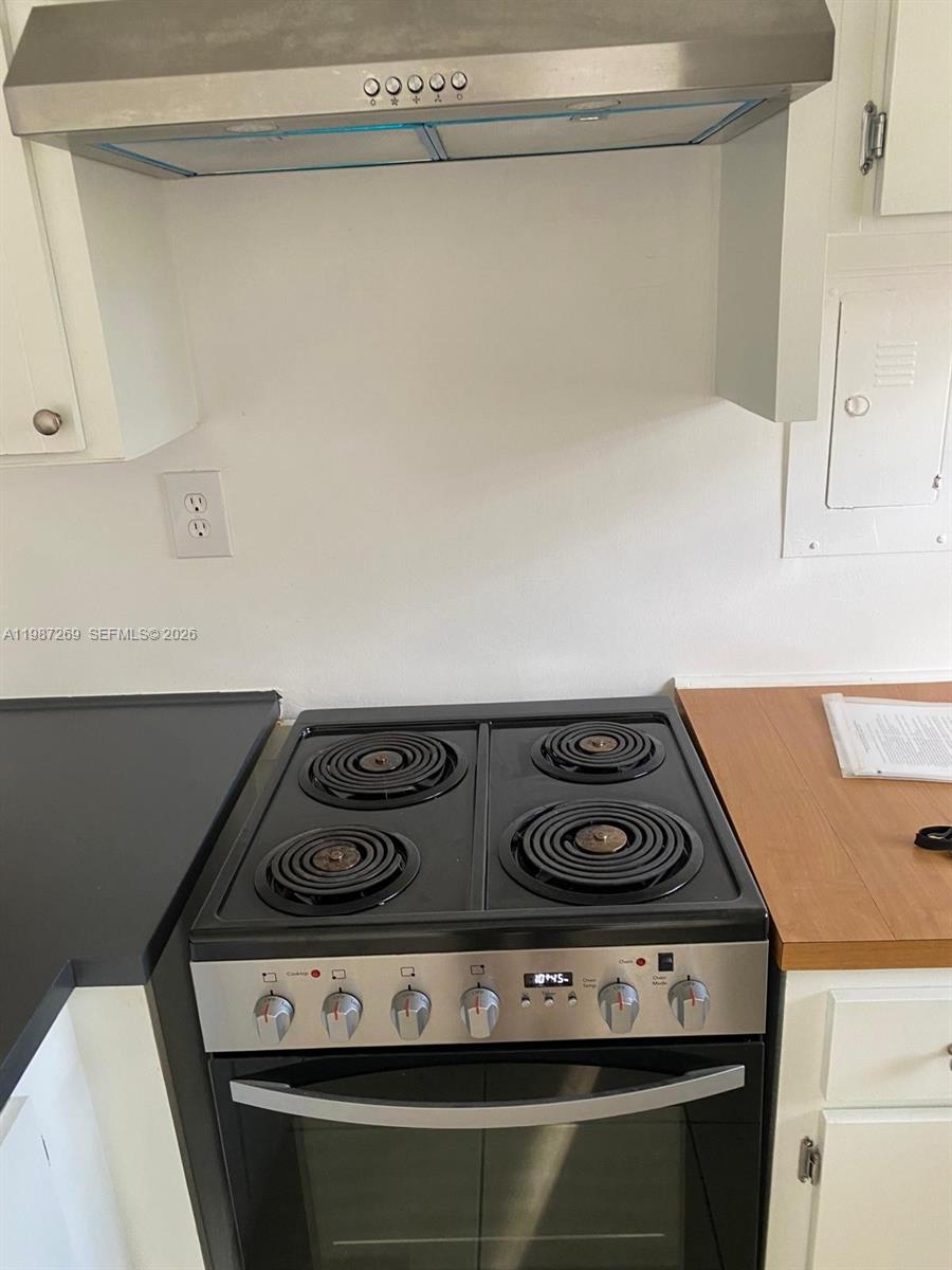 1755 Northeast 116th Road, Unit 8 North Miami, FL 33181 - Photo 7 of 23 a stove top oven sitting inside of a kitchen