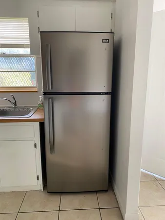 a refrigerator freezer sitting in a kitchen
