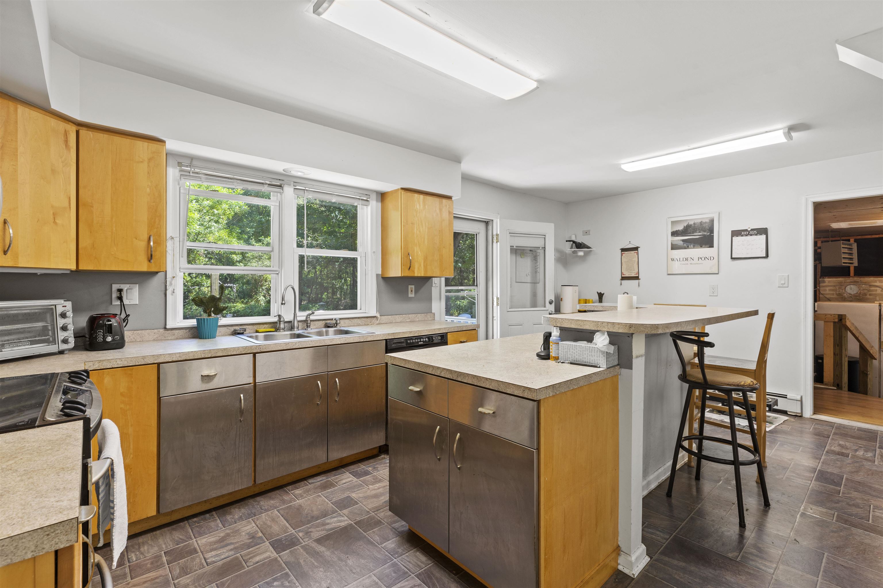 271 Hands Mill Road Belleplain, NJ 08270 - Photo 16 of 50 a kitchen with a stove a sink a dining table and chairs