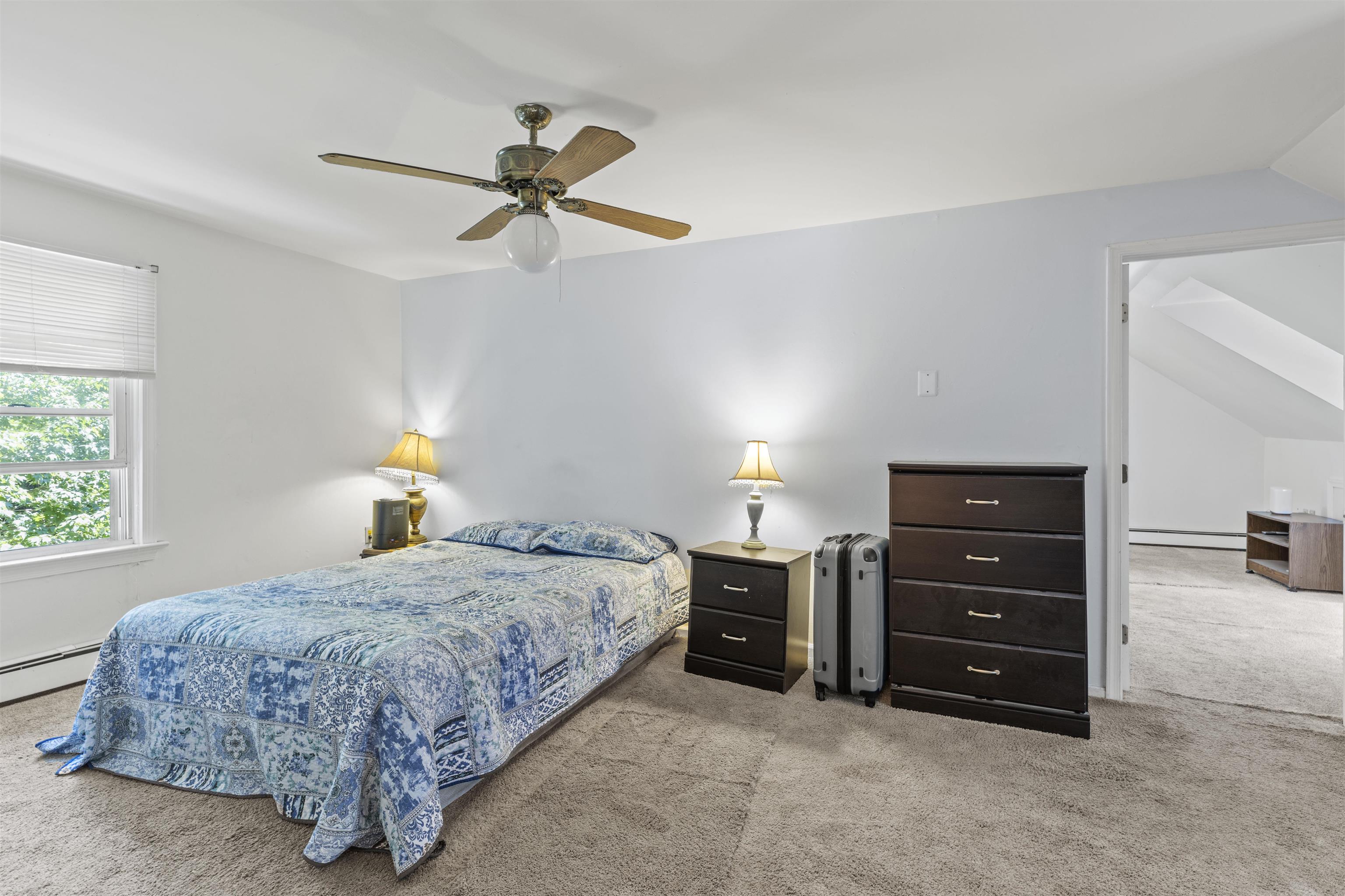 271 Hands Mill Road Belleplain, NJ 08270 - Photo 26 of 50 a bedroom with a bed and a chandelier