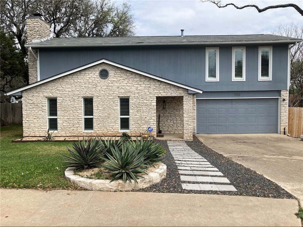 7903 Manassas Drive Austin, TX 78745 - Photo 1 of 1 a front view of a house with a yard and garage