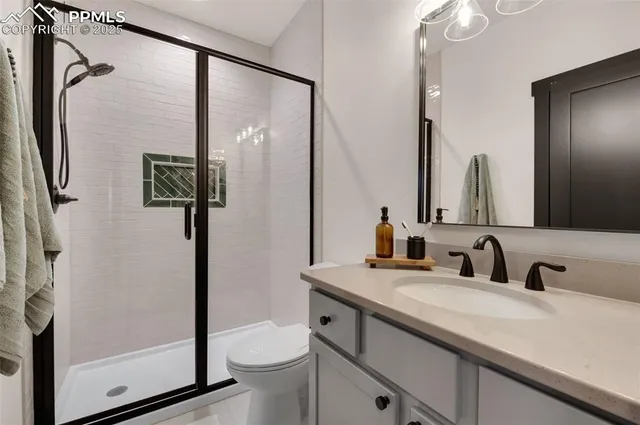 a bedroom with a bed and glass windows