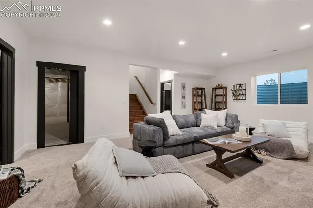 a spacious bedroom with a bed and a lamp