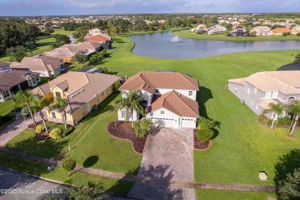 an aerial view of a house with a lake view