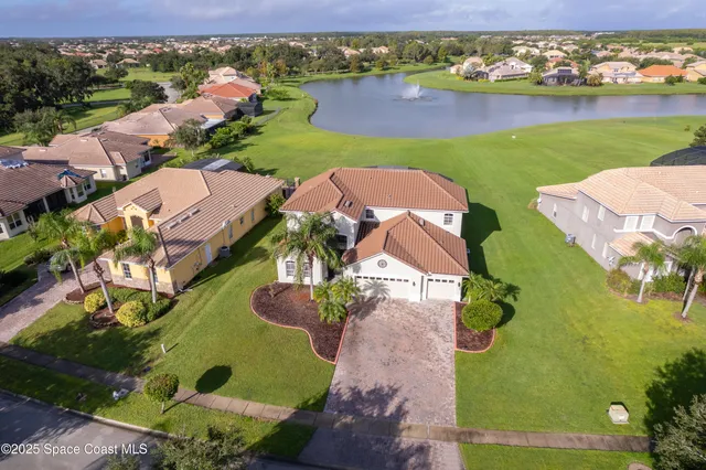 an aerial view of a house with a lake view