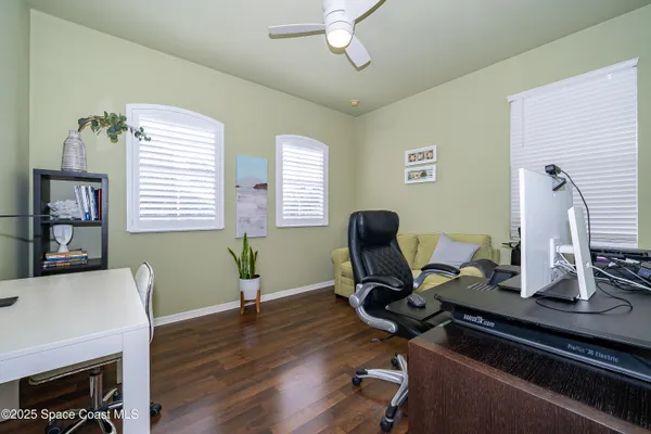 a view of a workspace with furniture and a window