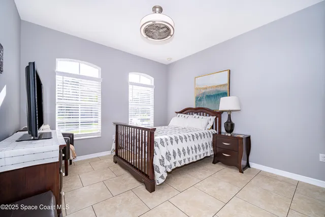 a room with a bed and a flat tv screen on a dresser