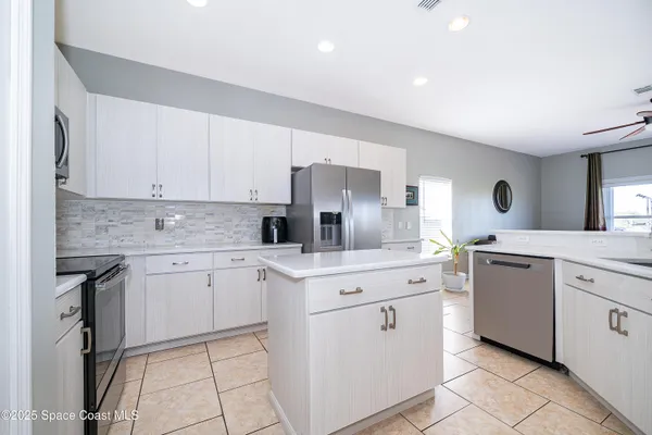 a kitchen with cabinets appliances and a counter